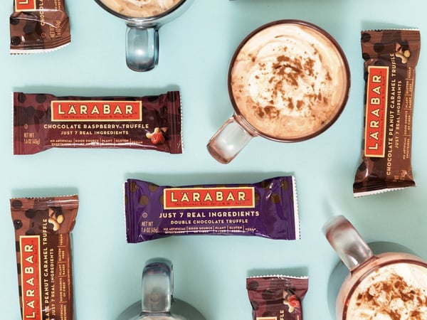 Larabar chocolate rasberry truffle and lattes on a teal background