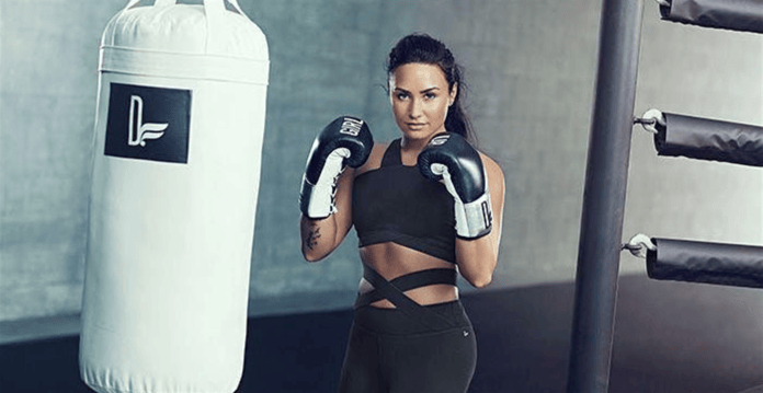 A model poses in a boxing-themed advertisement for Fabletics.