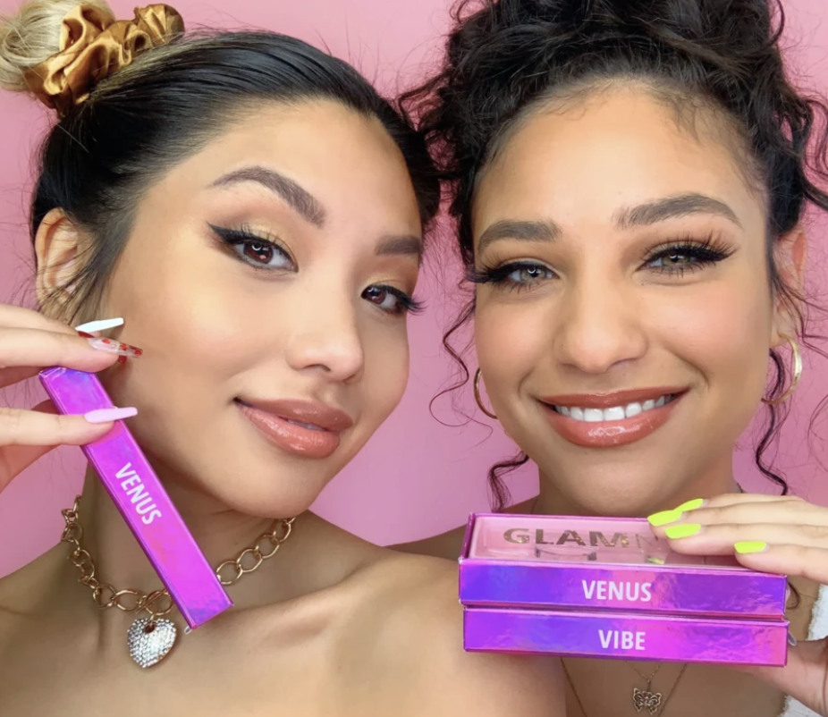 An advertisement for Glamnetic’s “Venus” and “Vibe” lashes featuring two women holding up the products.