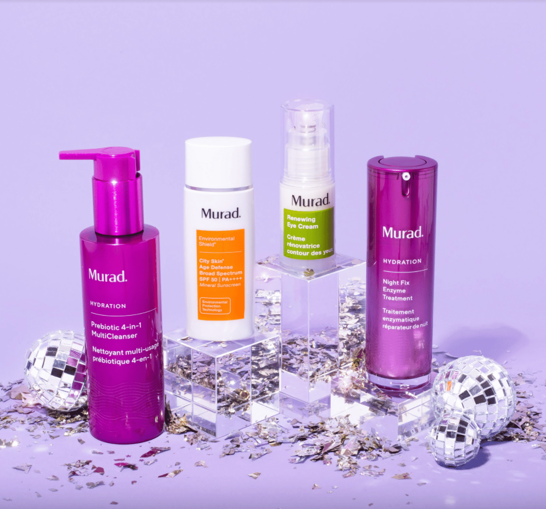 Various Murad clean skincare products arranged with miniature disco balls.