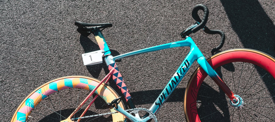 A colorful Specialized bicycle placed down on the tarmac.