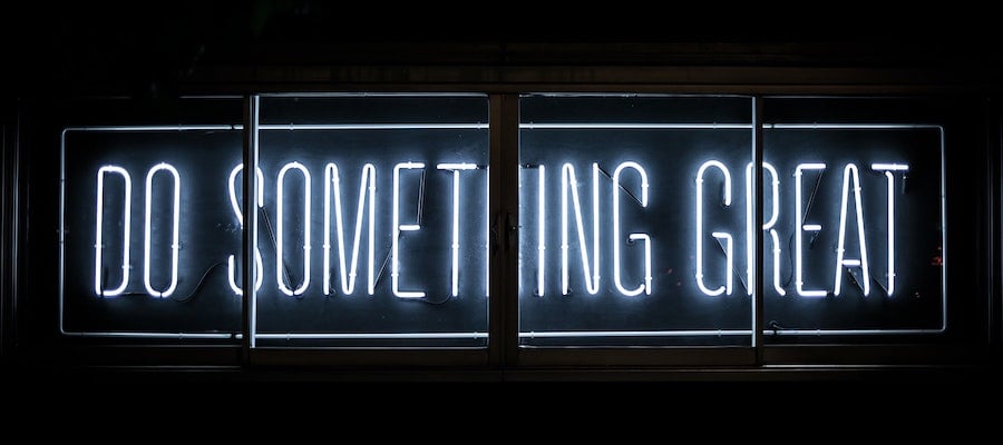 A neon sign reading “do something great,” by Clark Tibbs.