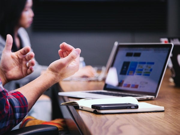 Two influencer marketers working on EMV at a desk, by Headway via Unsplash.