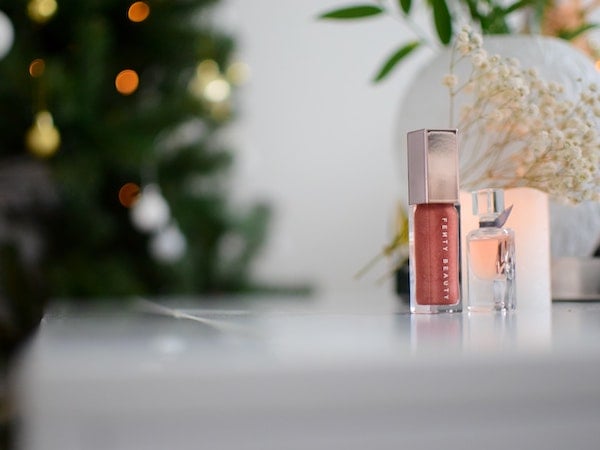 Two products from celebrity beauty brand Fenty Beauty displayed on a table, by Mercy via Unsplash.