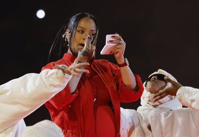 Rihanna puts on Fenty makeup during the Super Bowl halftime show