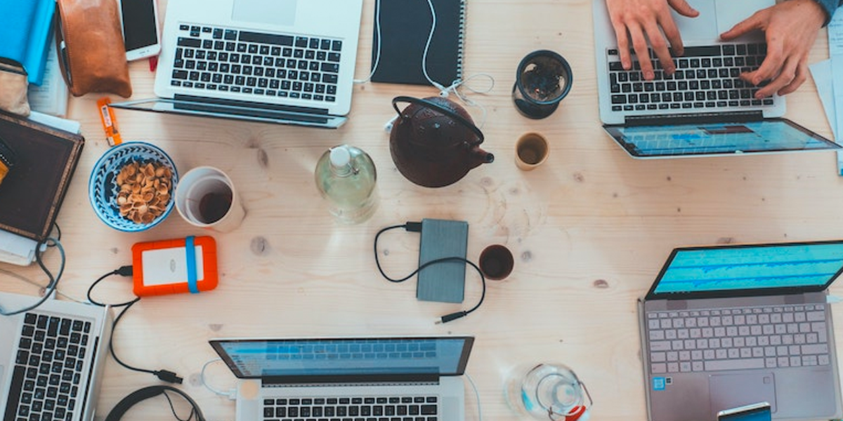 The shared desk of an influencer marketing team at work, by Marvin Meyer.