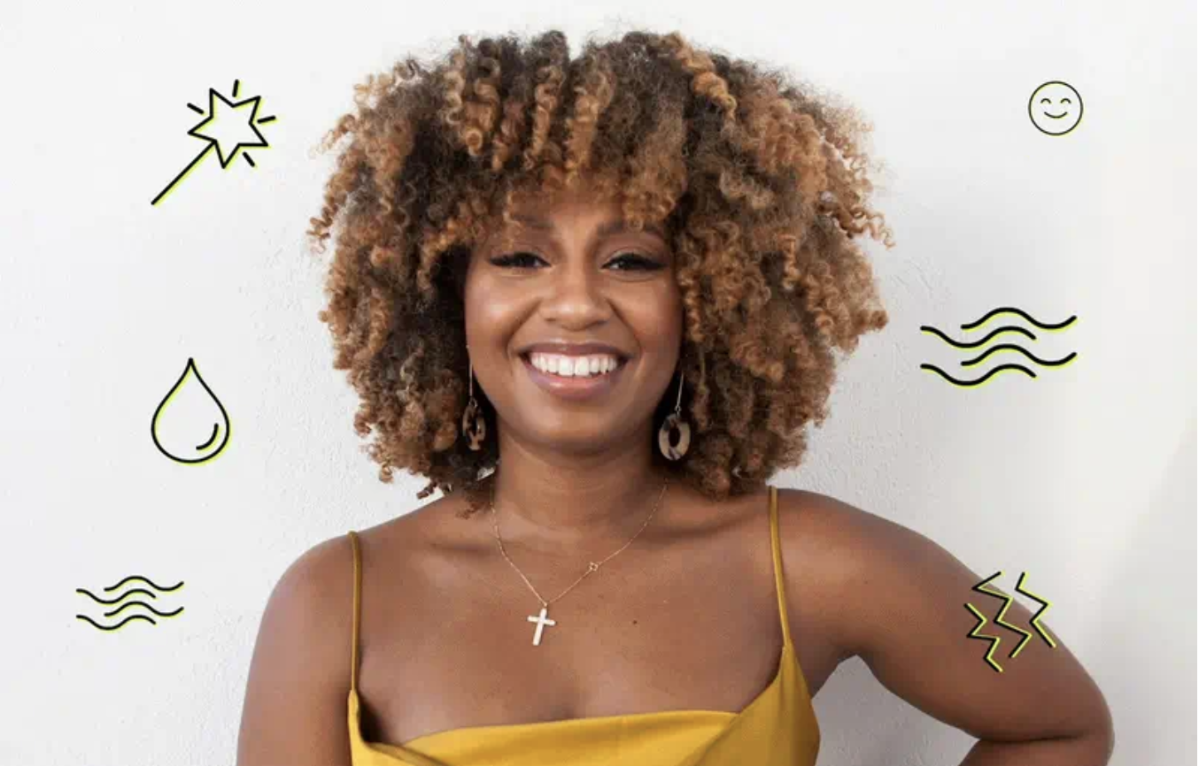 A photo of a smiling woman with short, curly hair.