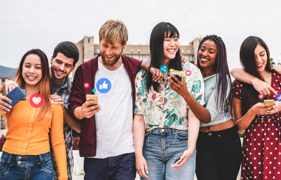 A photograph of a group of smiling people looking at and showing each other their phones.