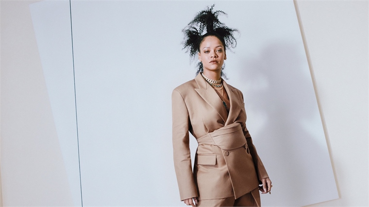 Singer Rihanna wears a beige coat from her Fenty DTC luxury fashion label. 