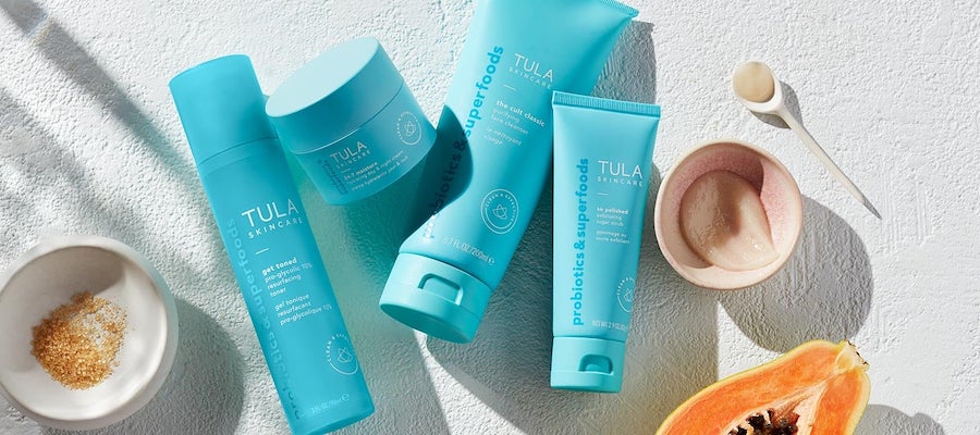Several TULA clean skincare products arranged with superfoods, via Tula.com